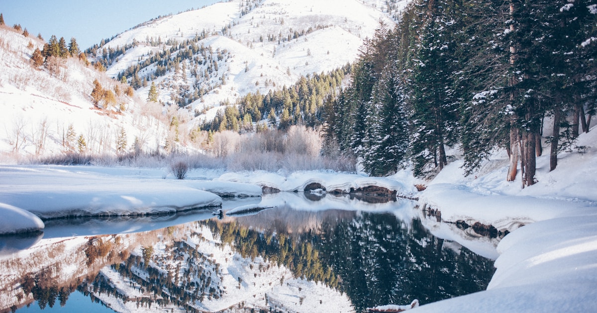Abstract watercolor of a still river mirroring snowy banks in perfect balance — holding acceptance and change at once