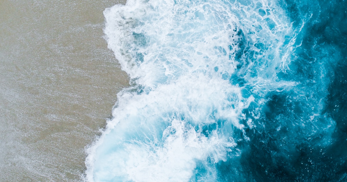 Abstract watercolor of turbulent surf churning just past a calm stretch of shore — the struggle hidden beneath a composed surface