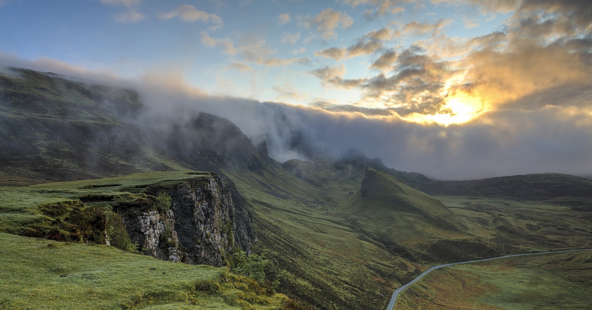 Soft dawn light over a mountain valley with fog lifting from the treeline — recognizing prescription opioid dependence without shame is the first step on the recovery path
